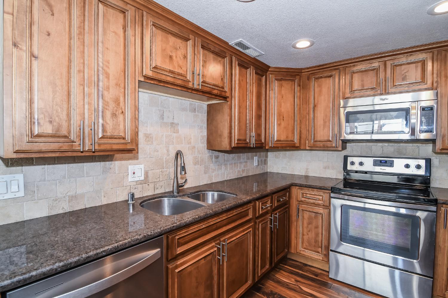 1139 Rivara Circle Sacramento, CA 95864 - Photo 21 of 72 a kitchen with stainless steel appliances granite countertop a sink a stove and cabinets