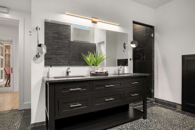 a bathroom with a sink vanity and a mirror