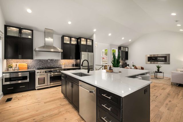 a kitchen with a sink stove and cabinets