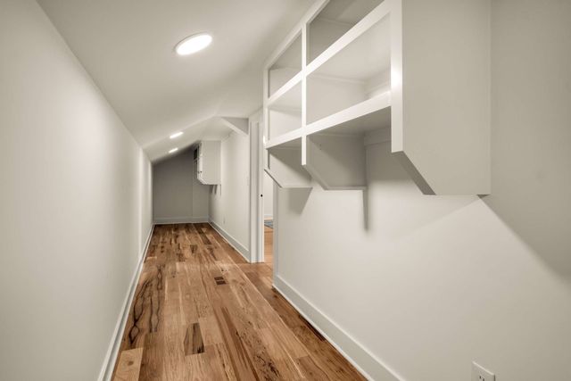 a bedroom with a bed and a chair