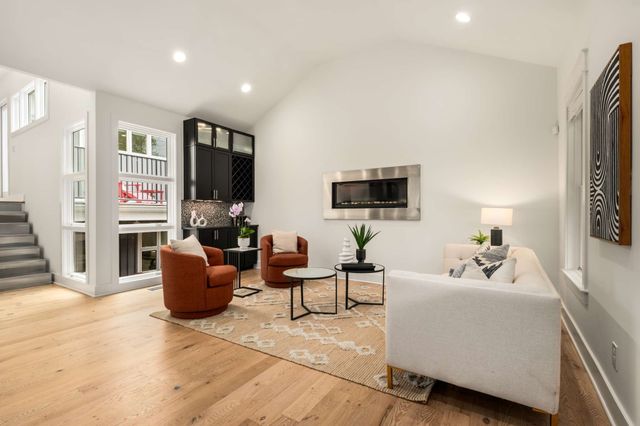 a living room with furniture and kitchen view