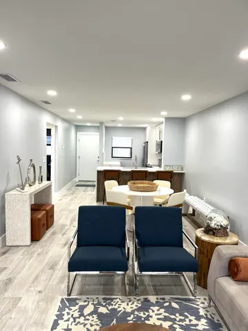 a kitchen with granite countertop a refrigerator stove and microwave