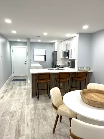 a kitchen with stainless steel appliances granite countertop a sink stove and cabinets