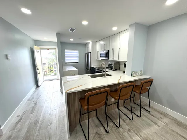 a bedroom with a bed and painting on the wall