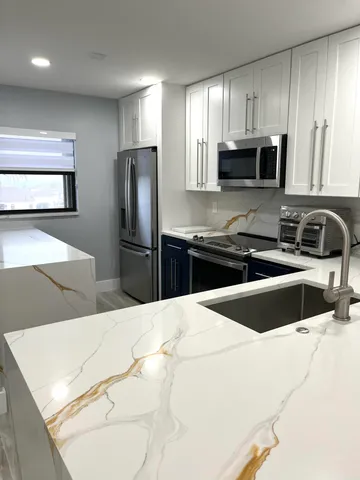 a bedroom with a bed and painting on the wall