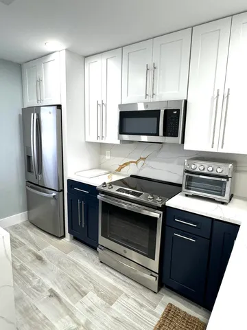 a bedroom with a bed and painting on the wall