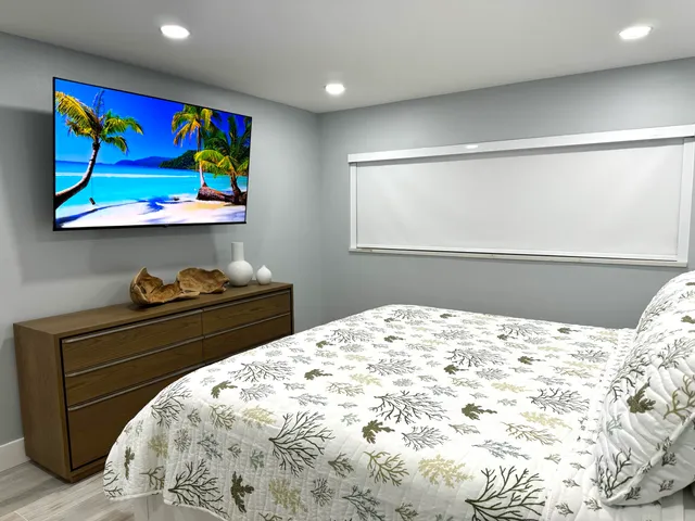 a bathroom with a granite countertop toilet sink and mirror