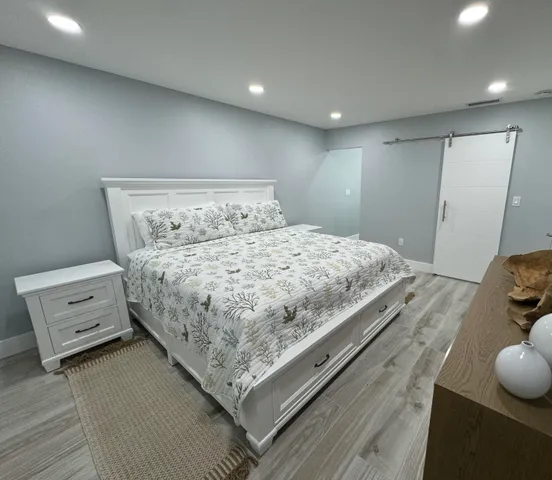 a spacious bathroom with a toilet sink and mirror