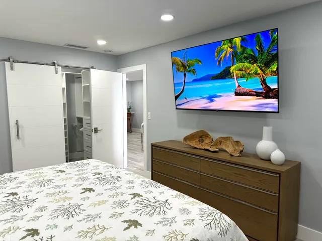 a bed sitting in a bedroom next to a window