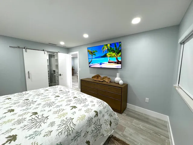 a bedroom with a bed and a night stand