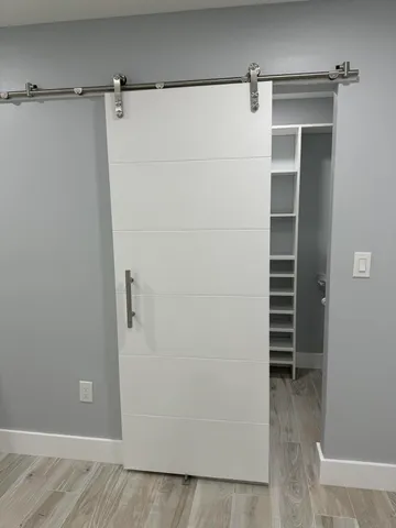 a bedroom with a bed and painting on the wall