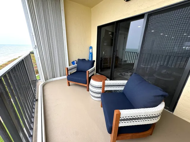 a view of a tennis ground with large trees
