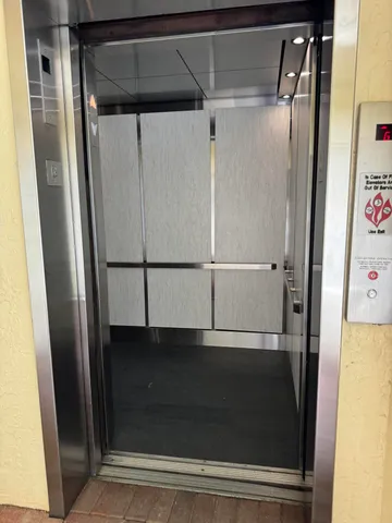 a wooden bench sitting in front of a building