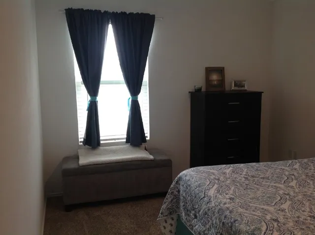 a large bed sitting in a bedroom and dresser