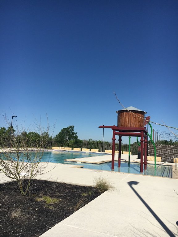 13801 Mussel Run Elgin, TX 78621 - Photo 16 of 18 a view of swimming pool with outdoor seating and yard in back