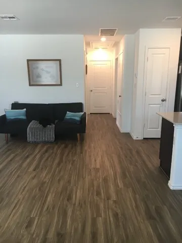 a view of a livingroom with furniture and wooden floor