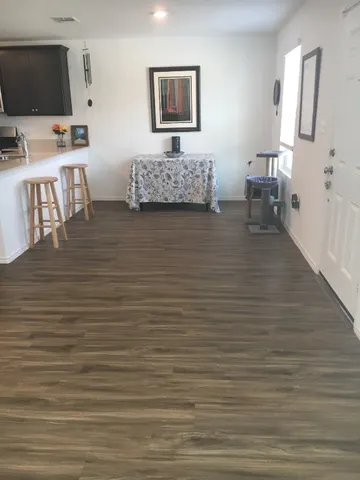 a kitchen with stainless steel appliances kitchen island granite countertop a refrigerator and a stove