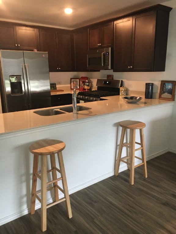 13801 Mussel Run Elgin, TX 78621 - Photo 7 of 18 a kitchen with a sink cabinets and wooden floor