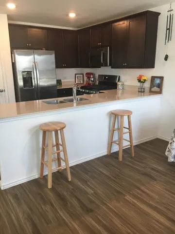 a kitchen with a sink cabinets and wooden floor