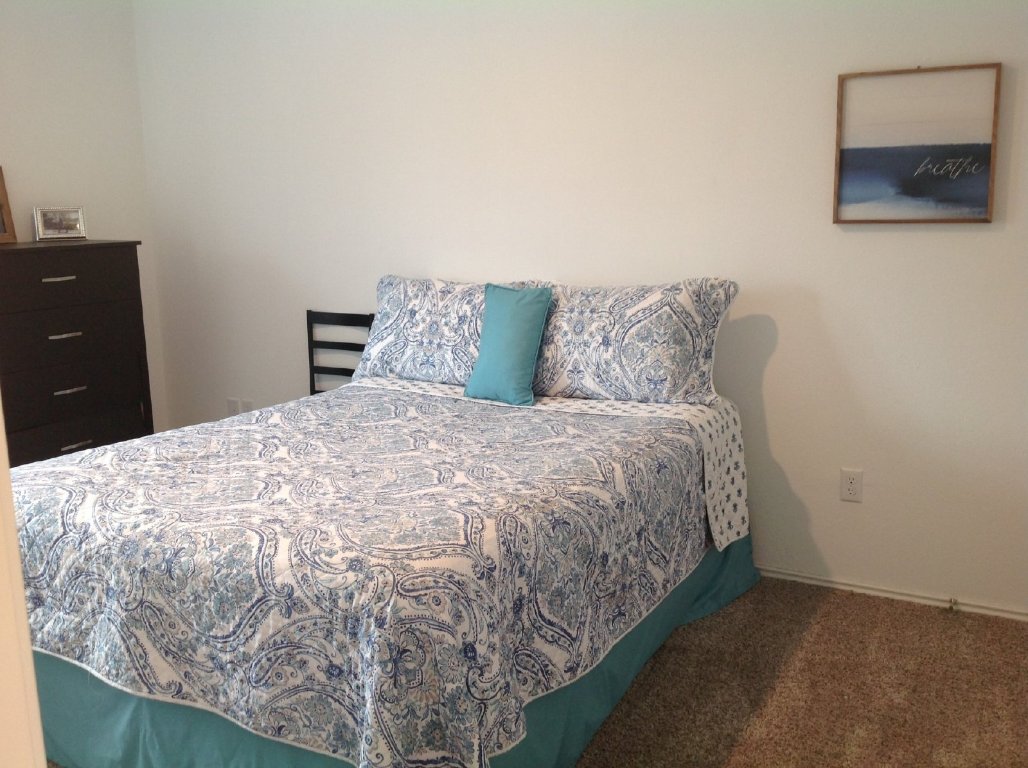 13801 Mussel Run Elgin, TX 78621 - Photo 9 of 18 a large bed sitting in a bedroom and dresser