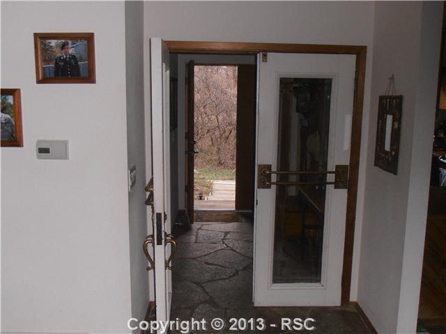 3685 El Rancho Way Monument, CO 80132 - Photo 5 of 25 note schist flooring, doors from Alamo hotel...old....