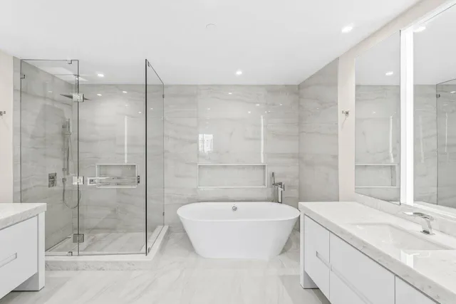 a bathroom with a double vanity sink mirror and shower