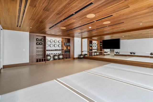 a view of a room with wooden floor and white walls