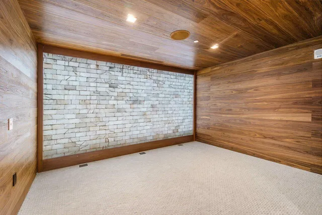 a large white room with a large mirror and sink