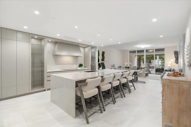 a large kitchen with kitchen island a sink stainless steel appliances and cabinets