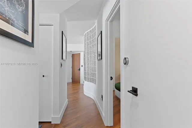 a view of a bathroom with a shower and a room