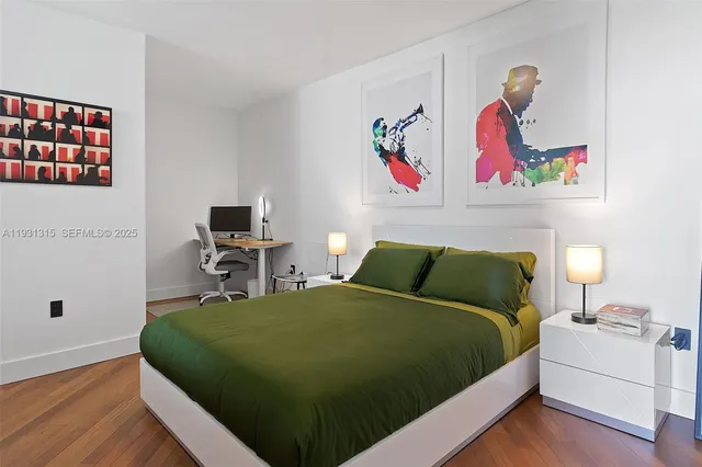 a bedroom with a bed and wooden floor