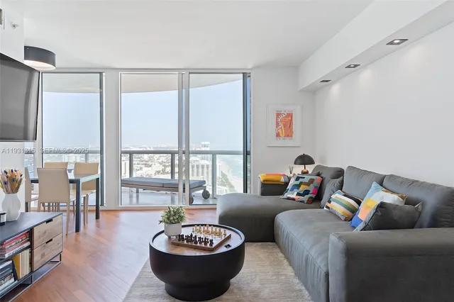 a living room with furniture and a large window