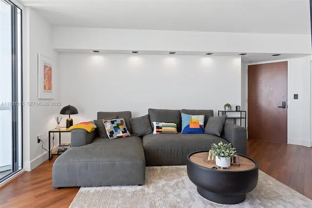 a living room with furniture and a potted plant