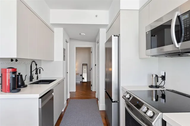 a kitchen that has a sink and a stove in it