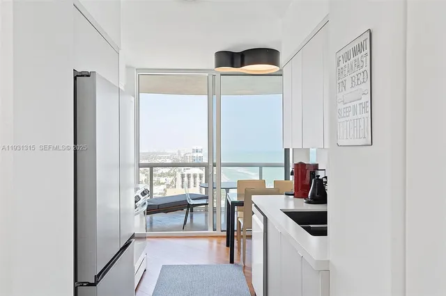 a kitchen with a sink a stove and a refrigerator