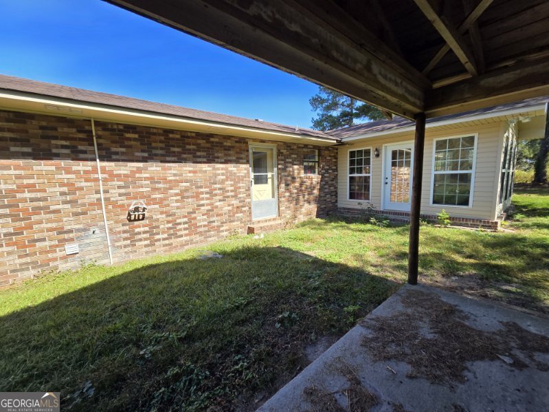 7307 Blocker Road Glennville, GA 30427 - Photo 3 of 6 a view of a house with backyard and porch