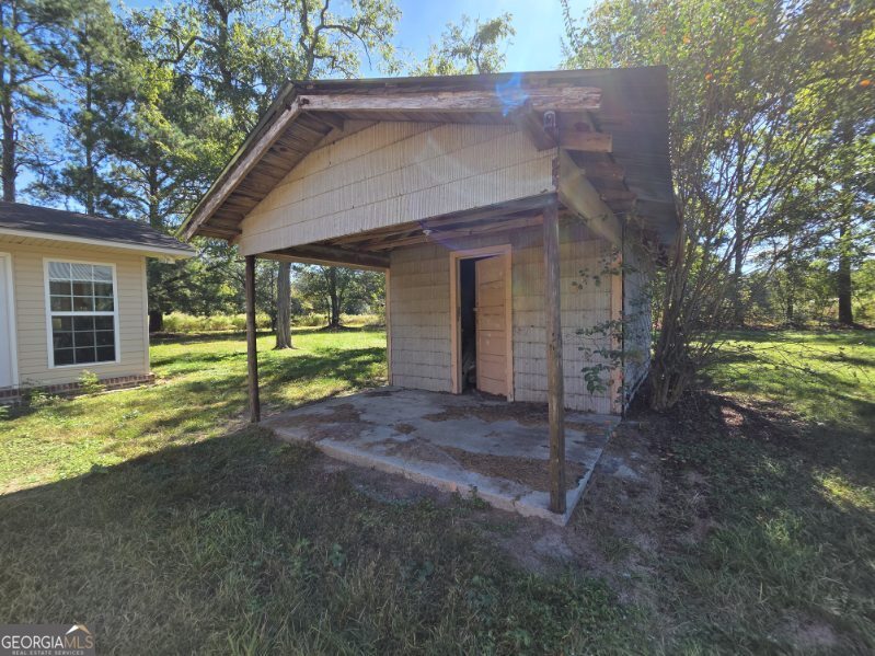 7307 Blocker Road Glennville, GA 30427 - Photo 4 of 6 a view of a house with backyard and a tree