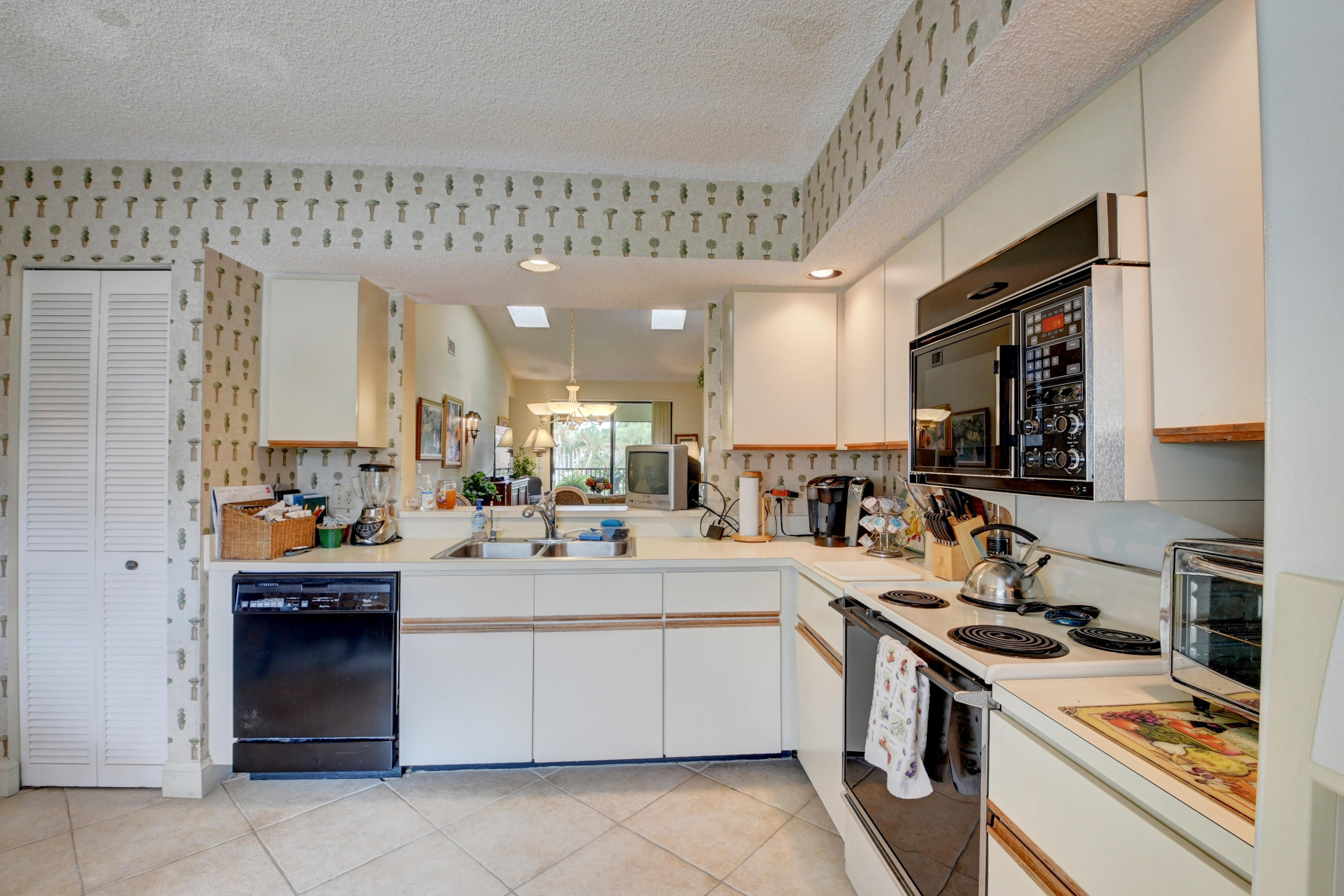 7861 La Mirada Drive Boca Raton, FL 33433 - Photo 17 of 26 a kitchen with a sink a stove top oven and cabinets