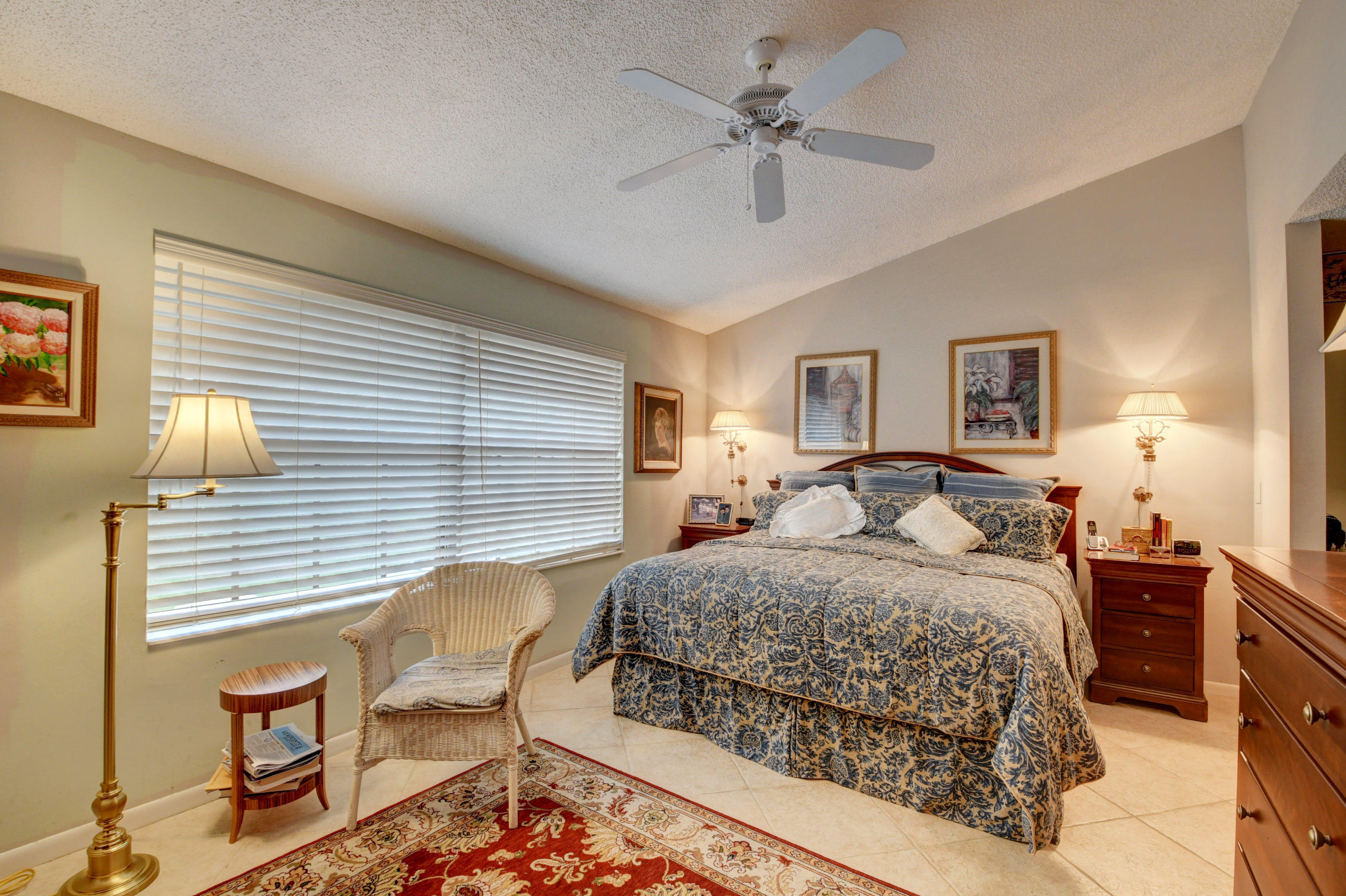 7861 La Mirada Drive Boca Raton, FL 33433 - Photo 19 of 26 a bedroom with a large bed and a chandelier