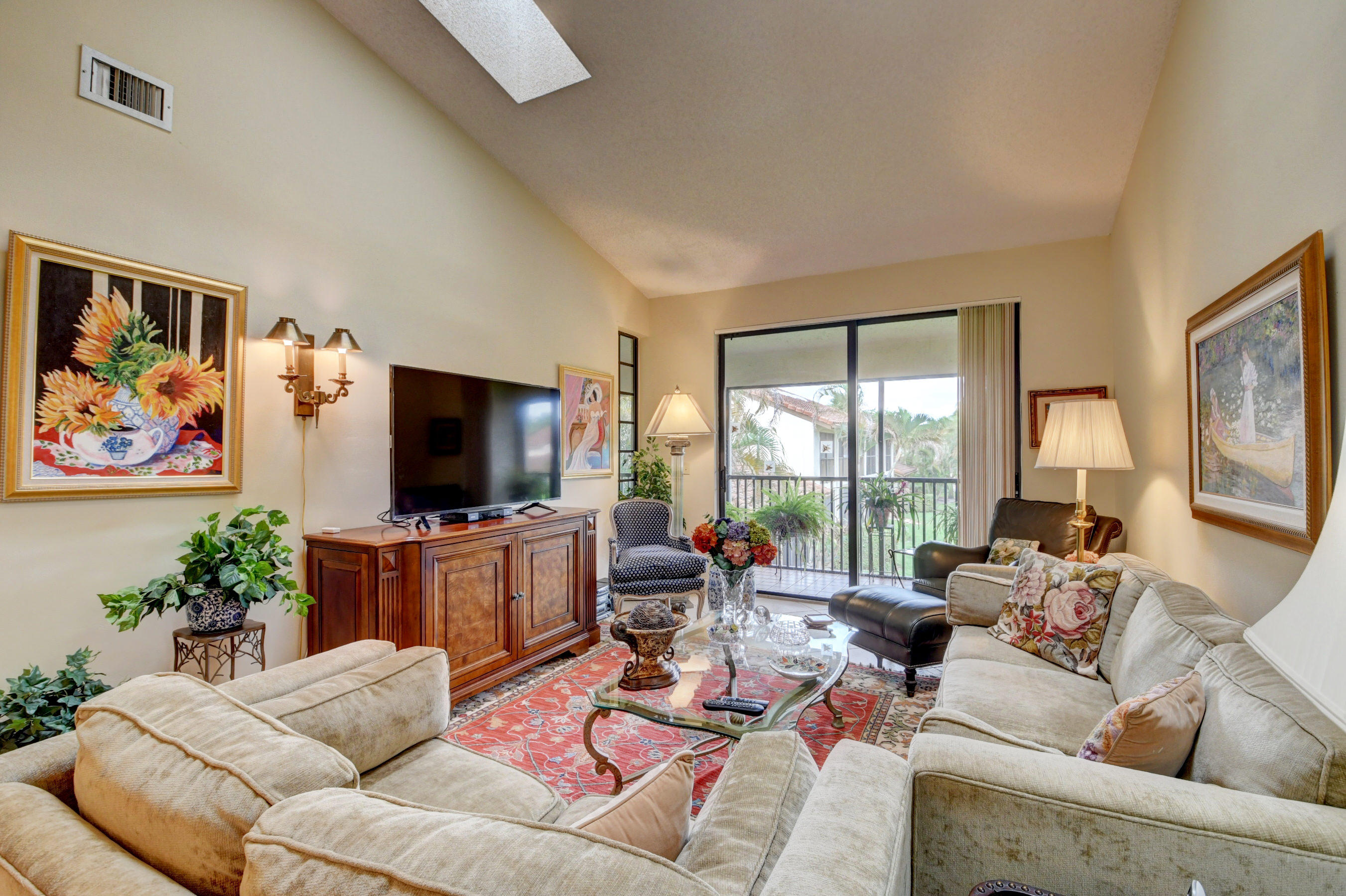7861 La Mirada Drive Boca Raton, FL 33433 - Photo 7 of 26 a living room with furniture a flat screen tv and a large window