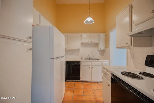 a kitchen with a stove a sink and a refrigerator