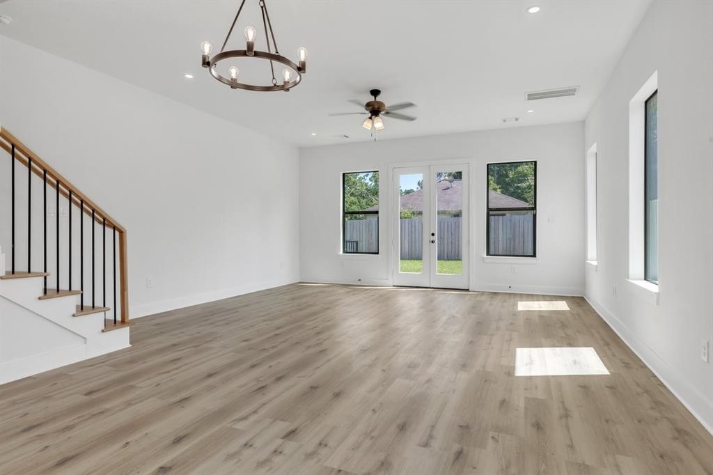 311 Tennessee Street Houston, TX 77029 - Photo 2 of 15 a view of an empty room with wooden floor and windows
