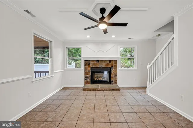 a view of an empty room with a fireplace and a window