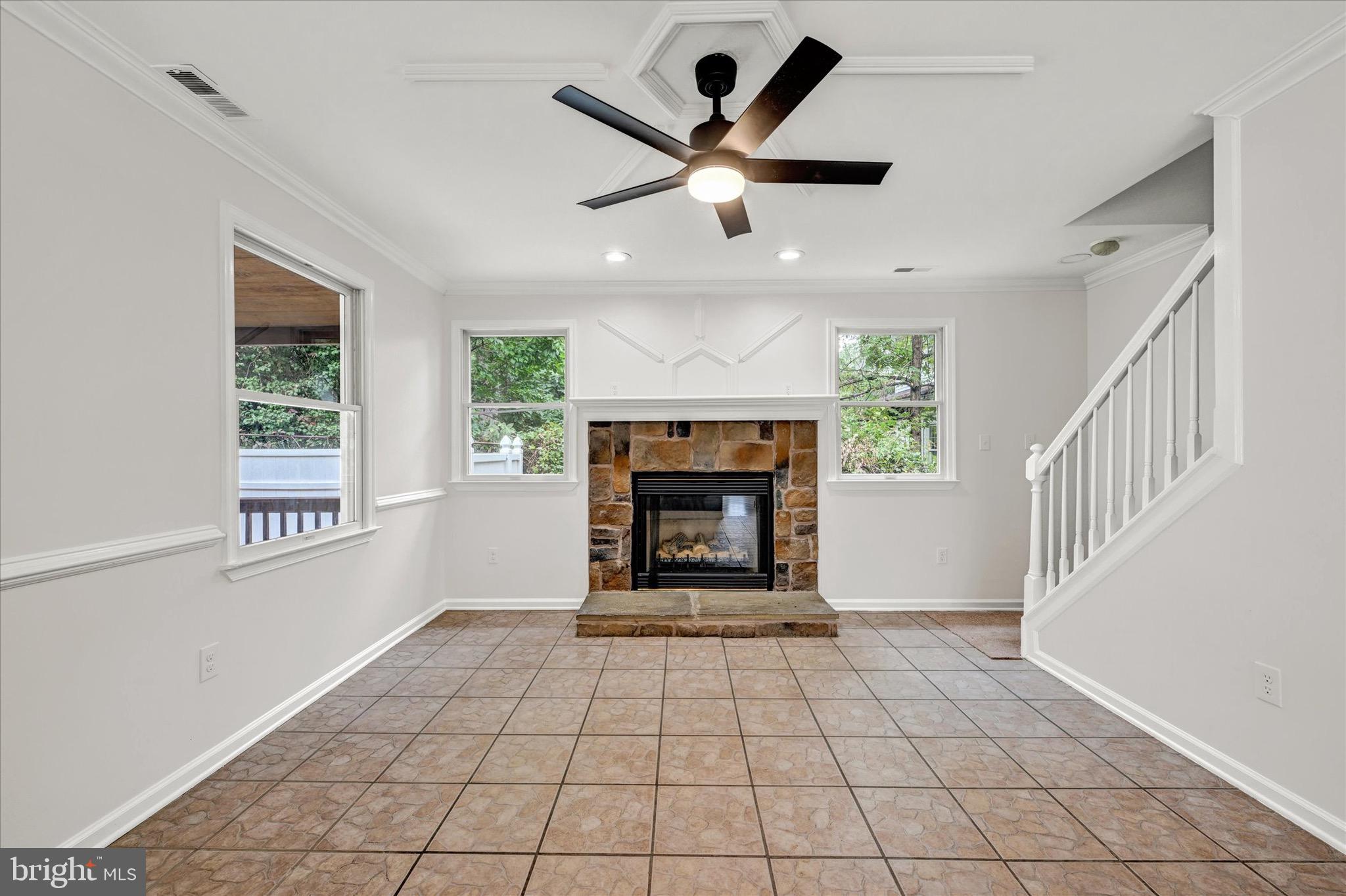 2108 Sunbriar Road Baltimore, MD 21207 - Photo 11 of 50 a view of an empty room with a fireplace and a window