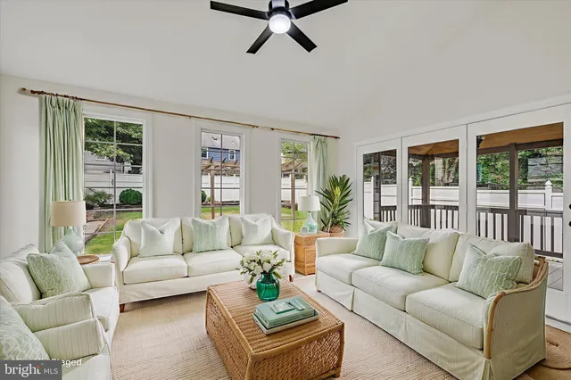 a living room with furniture and large windows