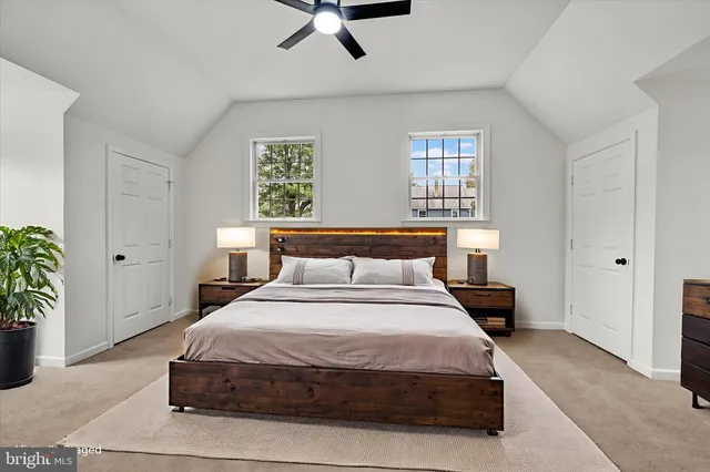 a bedroom with a bed and potted plant