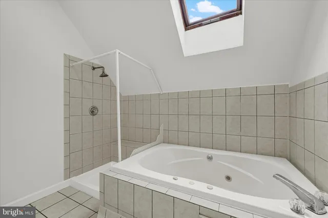 a bathroom with a bathtub and shower
