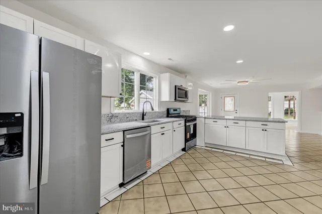 a kitchen with granite countertop cabinets and stainless steel appliances