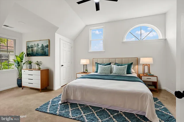 a bedroom with a bed and a desk