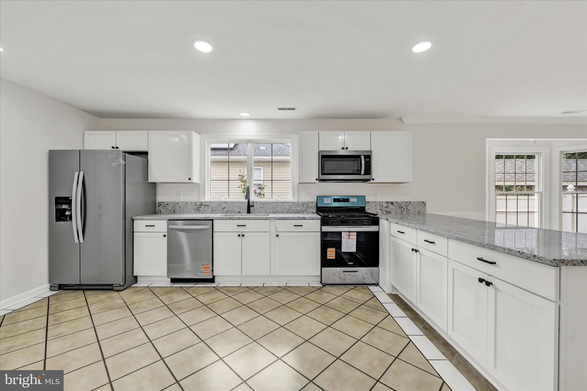 2108 Sunbriar Road Baltimore, MD 21207 - Photo 3 of 50 a kitchen with a sink a counter top space stainless steel appliances and cabinets